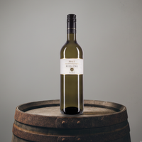 Wine bottle labeled 'Pfalz Riesling' on a wooden barrel with a gray background